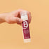 A hand holding a Berodin soothing cream bottle
